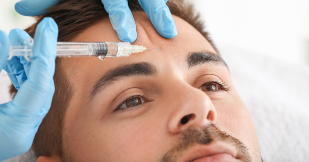 Man receiving treatment on his forehead