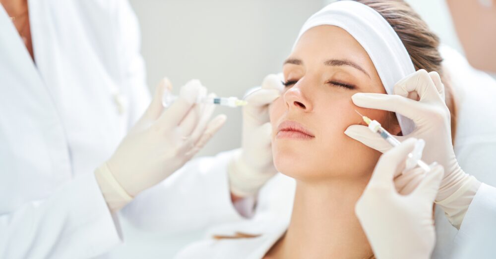 Woman with a headband receiving a Botox injection