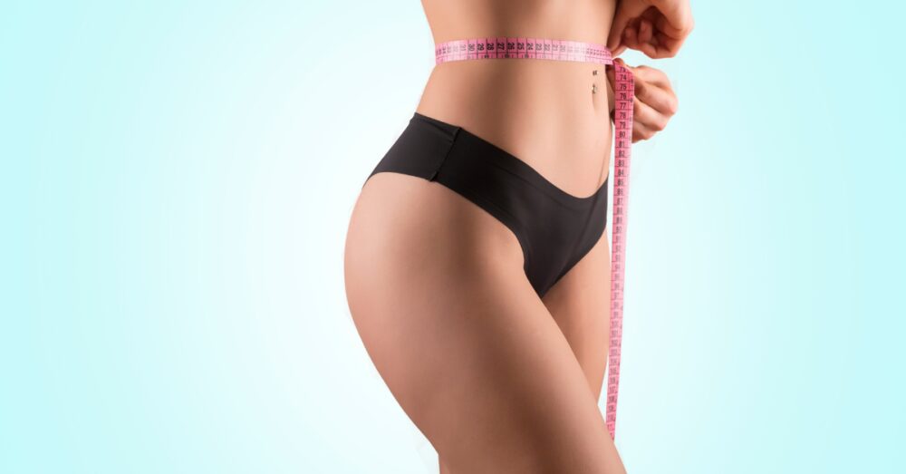 Woman with a tape measure around her waist signifying body contouring results